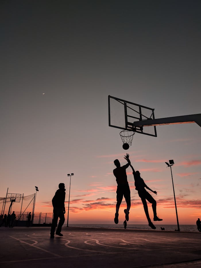 Silhouette of People Playing Basketball during Sunset